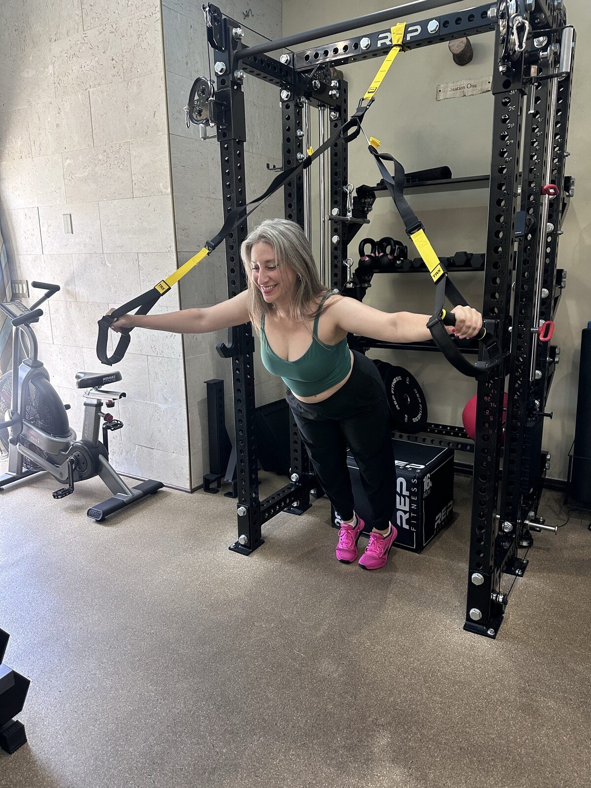 Erica coaching a TRX bench session